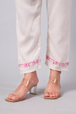 Detailed view of pink Aari embroidery on white co-ord set pants