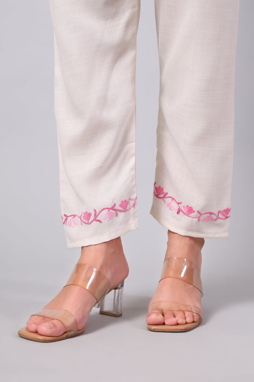 Detailed view of pink Aari embroidery on white co-ord set pants