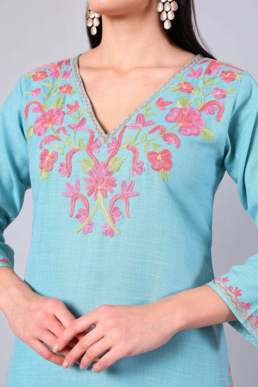 Close-up of coral pink Kashmiri Aari embroidery on aqua blue co-ord set neckline