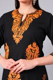 Close-up of burnt orange Kashmiri Aari embroidery on black co-ord set neckline