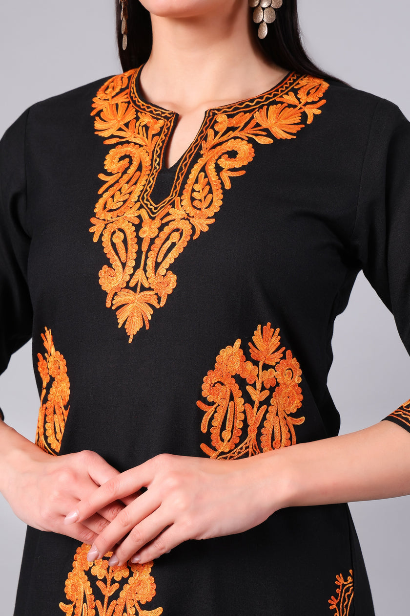 Close-up of burnt orange Kashmiri Aari embroidery on black co-ord set neckline