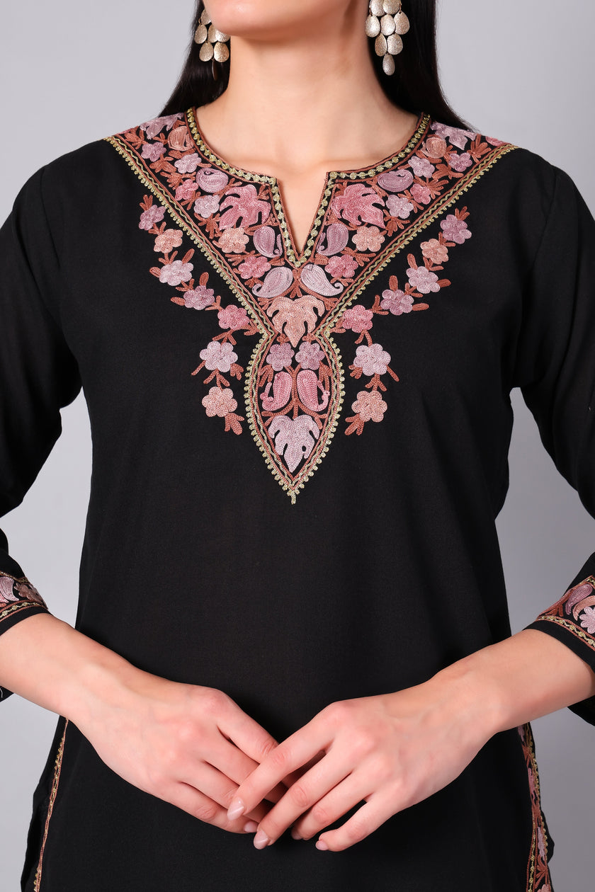 Close-up of intricate pink Kashmiri Aari embroidery on neckline of black co-ord set