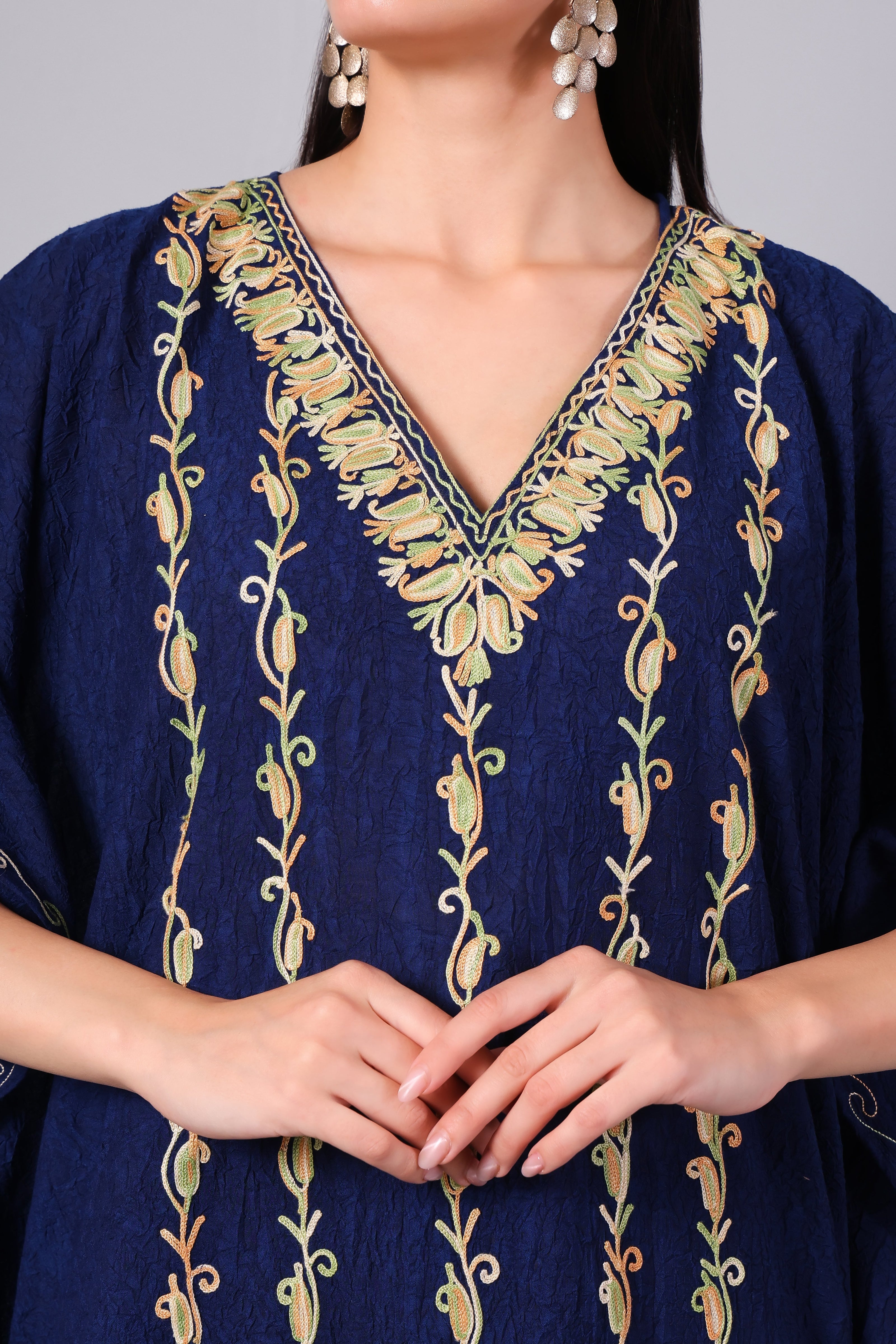 Close-up of multicolour vine Kashmiri Aari embroidery on midnight blue kaftan neckline