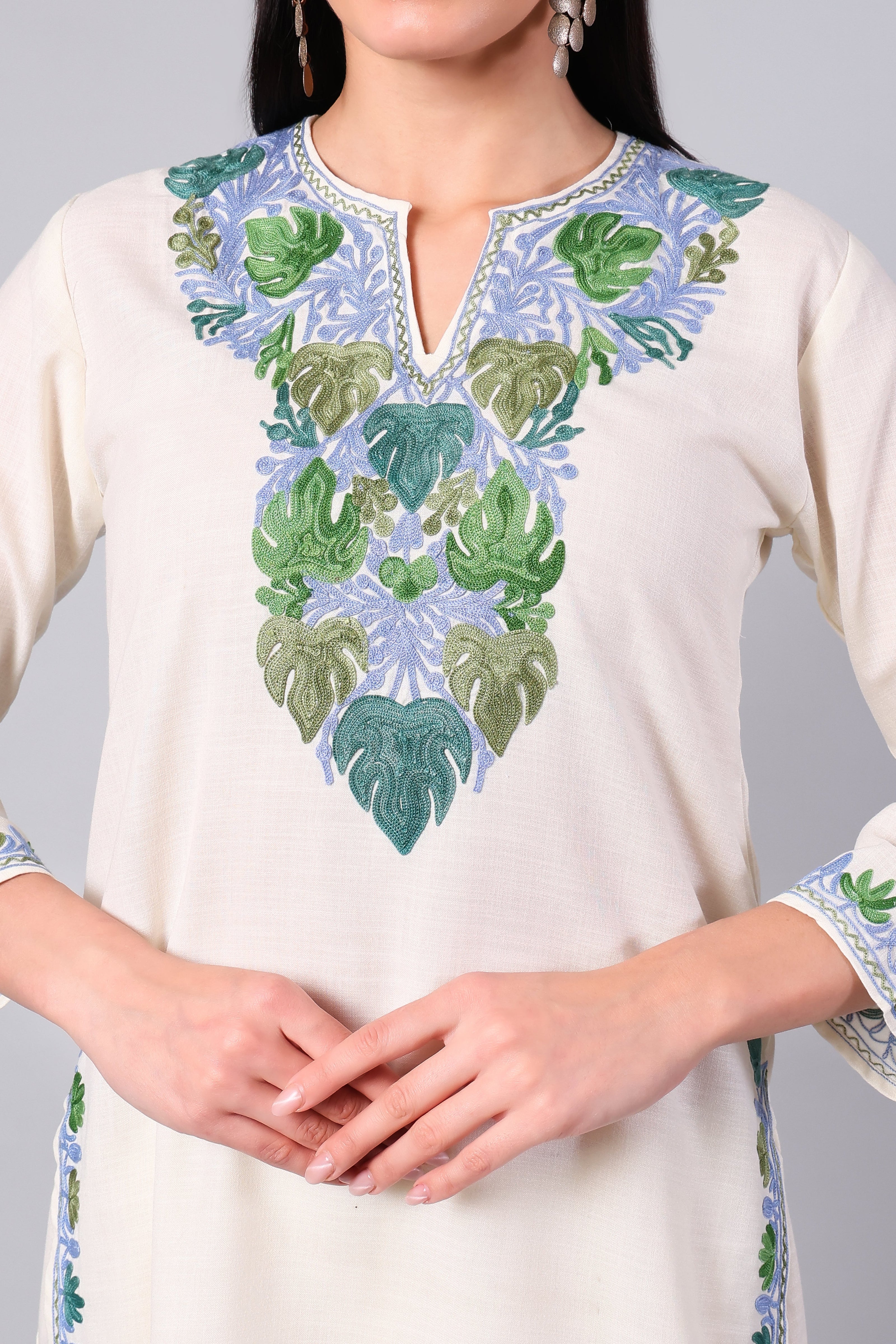 Close-up of Kashmiri Aari embroidery in green and blue on ivory co-ord set neckline