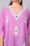 Close-up of white Kashmiri Aari floral embroidery on orchid pink kaftan neckline