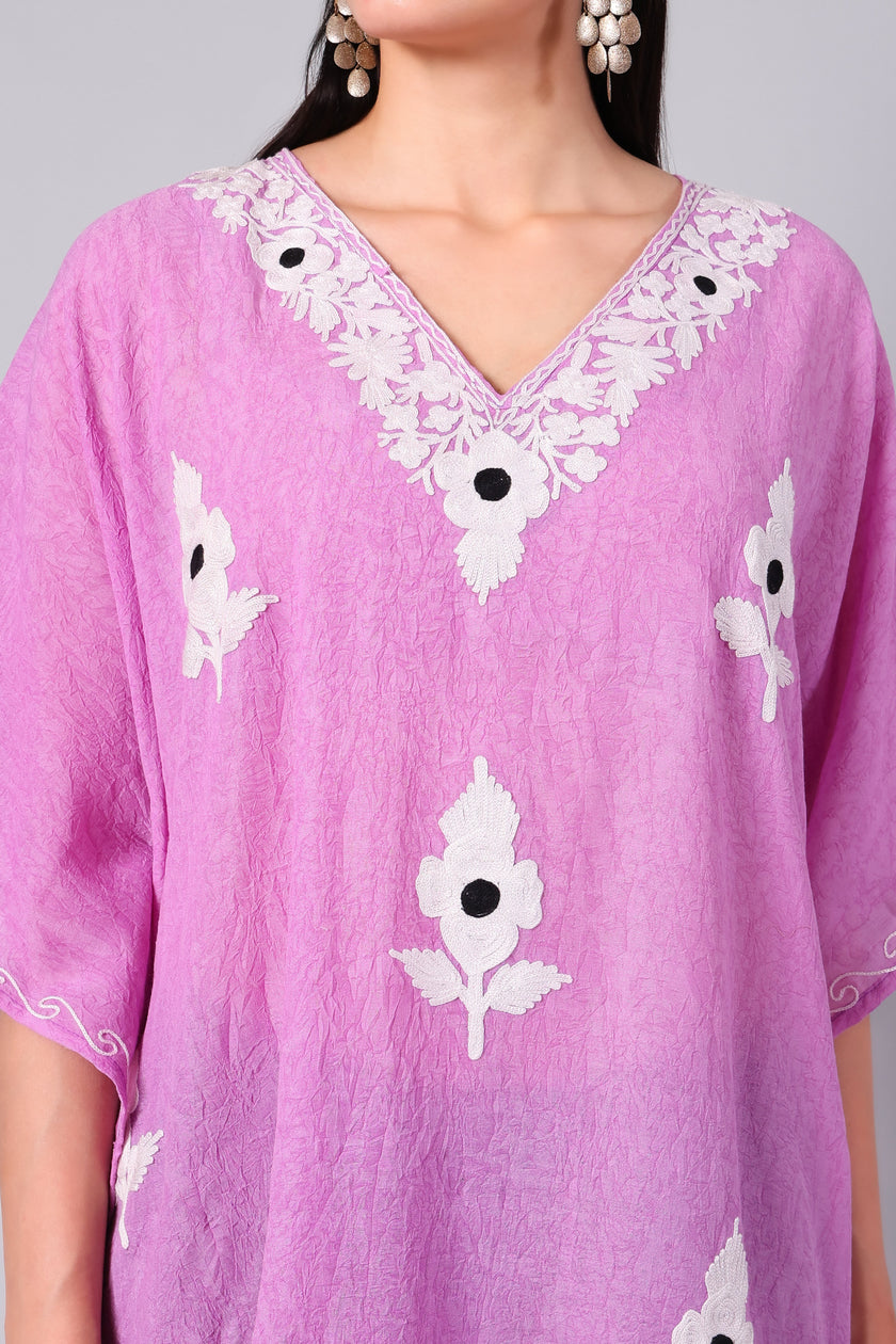 Close-up of white Kashmiri Aari floral embroidery on orchid pink kaftan neckline