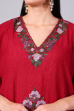 Close-up of multicolour Kashmiri Aari floral embroidery on crimson red kaftan neckline