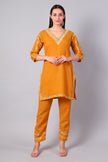 Front view of sunlit amber Kashmiri Aari co-ord set with green embroidery for women