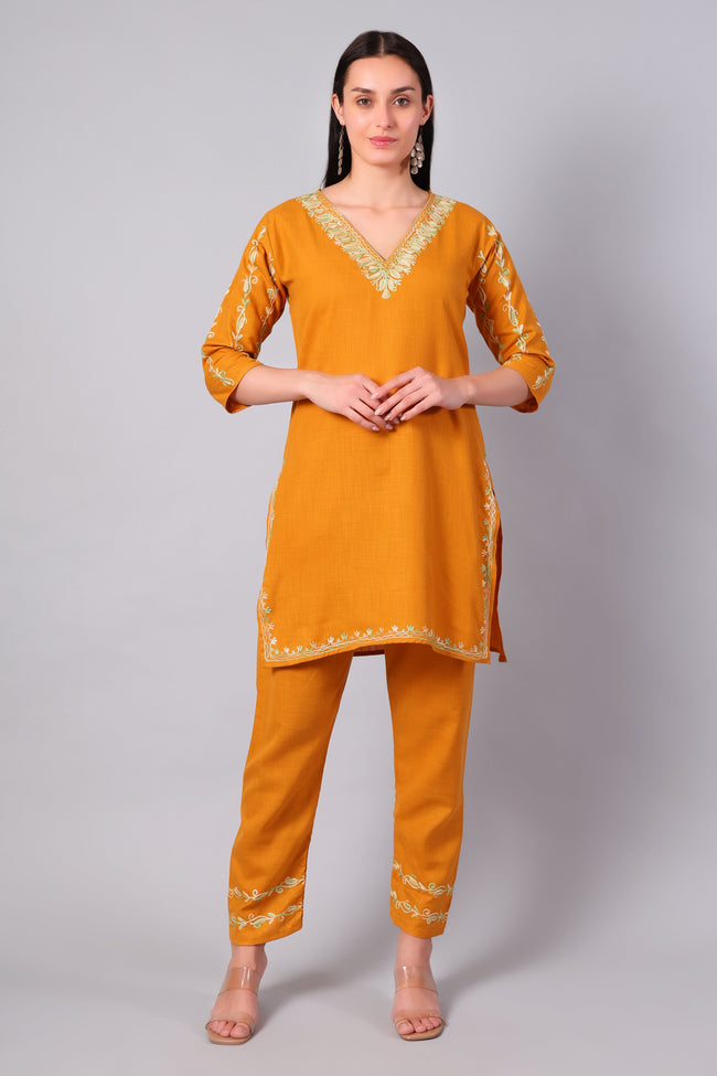 Front view of sunlit amber Kashmiri Aari co-ord set with green embroidery for women