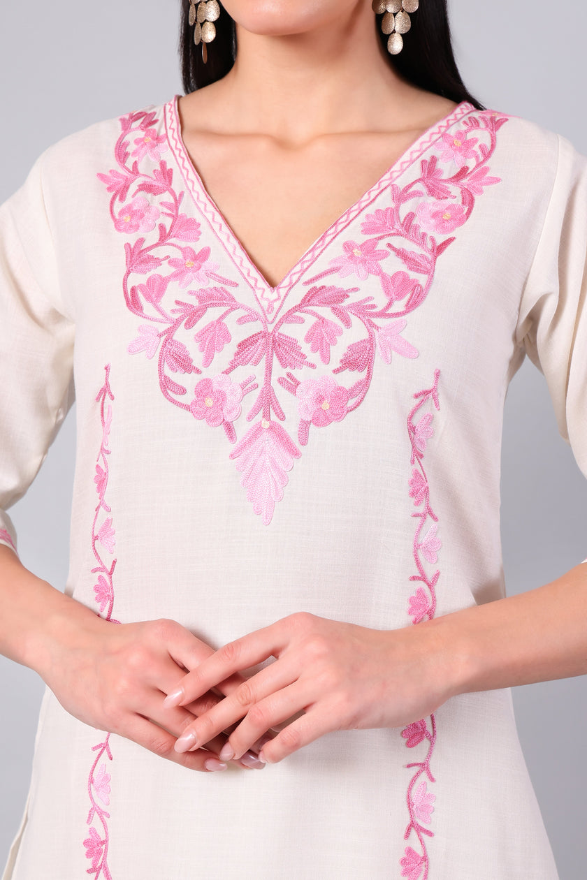 Close-up of pink Kashmiri Aari embroidery on white co-ord set neckline