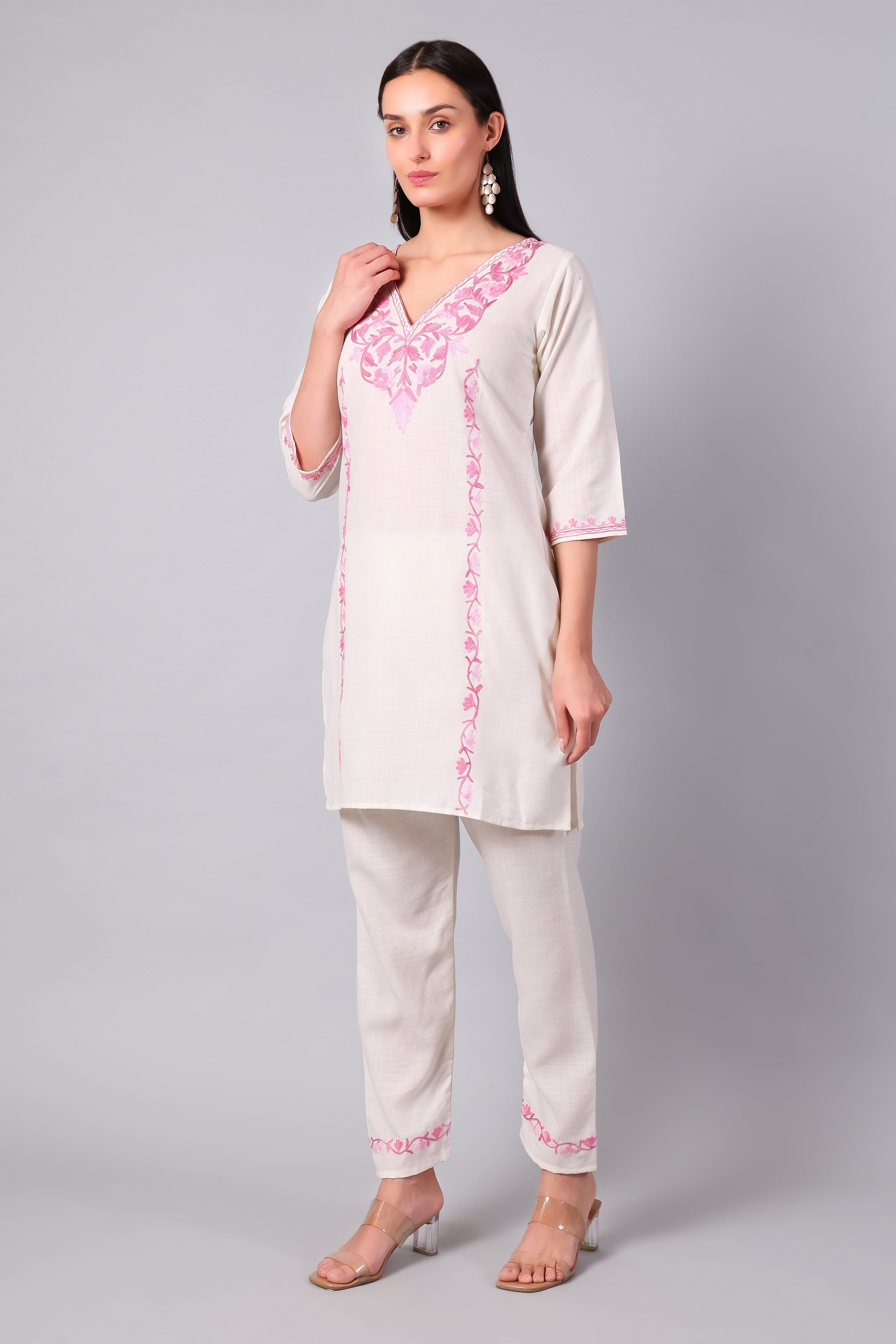 Full outfit of white Aari embroidered co-ord set with straight pants for women
Detailed view of pink Aari embroidery on white co-ord set pants