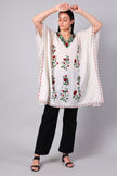 Novbahar white Kashmiri kaftan — front angle with red and green embroidery detail
